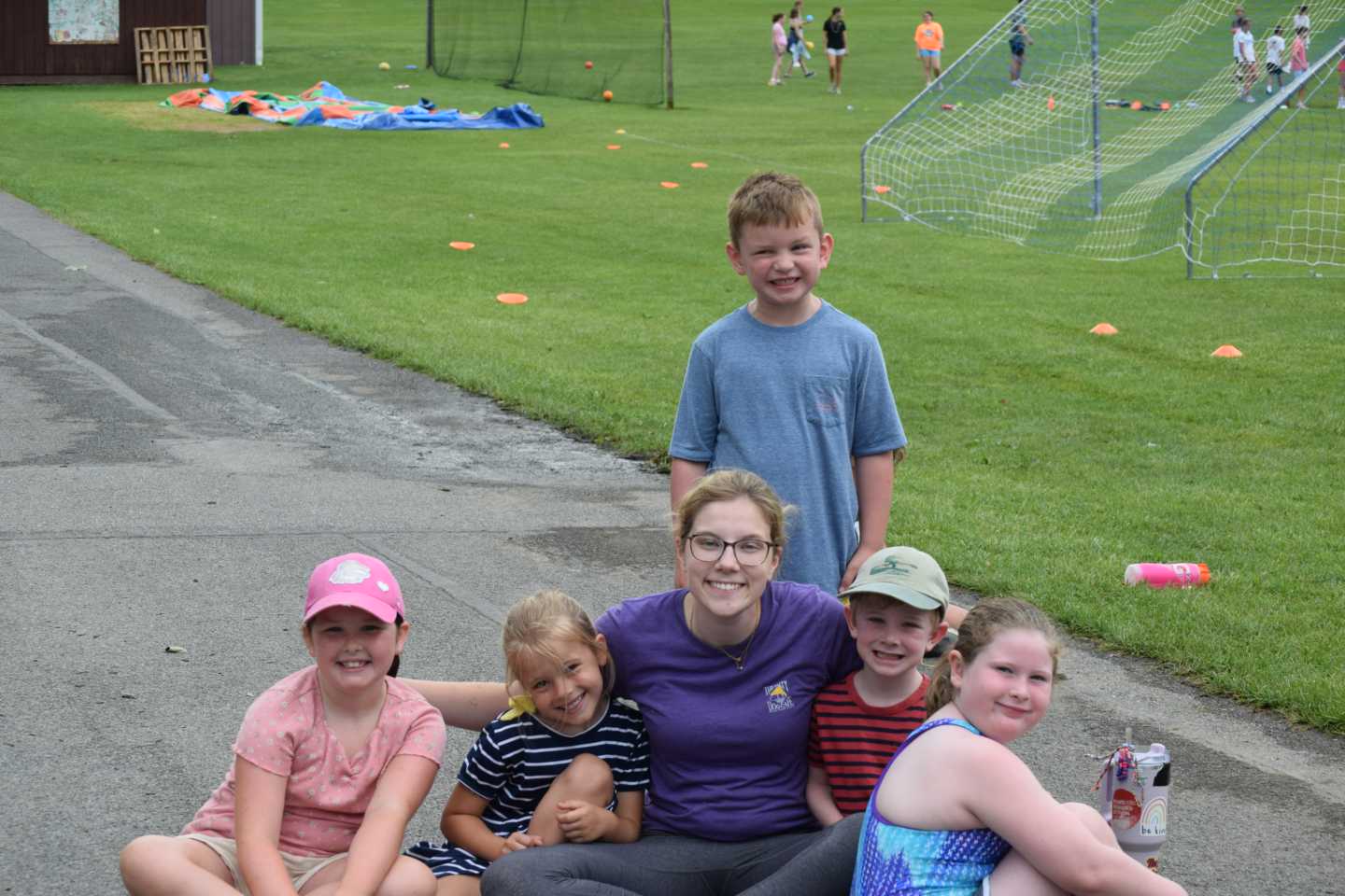 5 children posing for picture with a female counselor. 